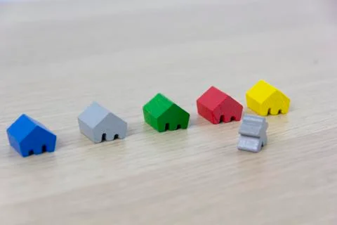 Different colored game pieces representing different houses, concept of choic 写真素材