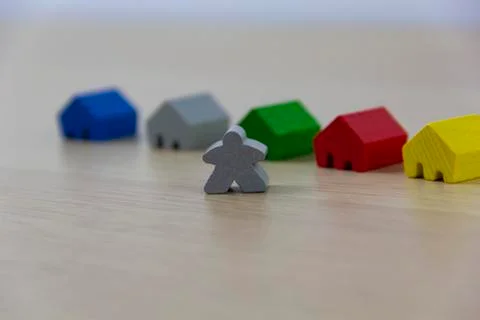 Different colored game pieces representing different houses, concept of choic Foto stock