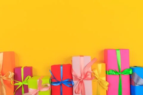 Different colored gift box on color background. Top view of various present b Stock Photos