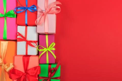 Different colored gift box on color background. Top view of various present b Stock Photos