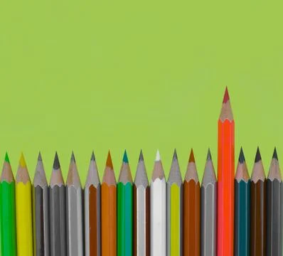 Different colored pencil crayon placed as a waved form row on a light green p Stock Photos