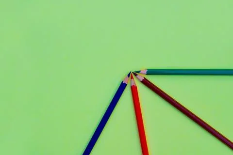 Different colored pencil crayons arranged in a quarter circle on a paper back Foto stock