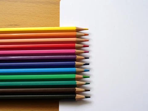 Different colored pencils next to note book with blank page 写真素材