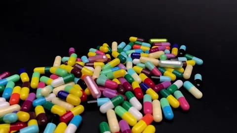 Different colored pills on a turntable Stock Footage 252485098