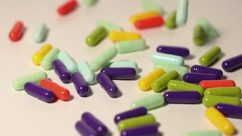 Different colored pills on a turntable Stock Footage 252485149