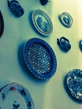 Different colored plates on the wal Stock Photos