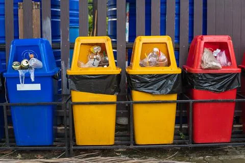 Different colored recycle garbage trash Bins in the park. Stock Photos