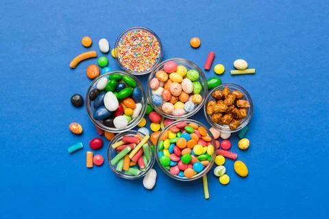Different colored round candy in bowl and jars. Top view of large variety s.. Fotos Stock