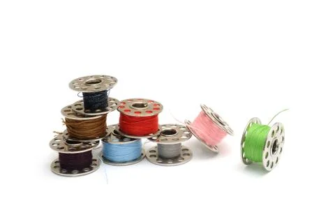 Different colored sewing machine bobbins Stock Photos