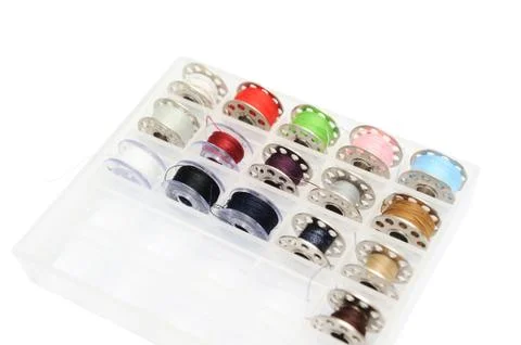 Different colored sewing machine bobbins Stock Photos