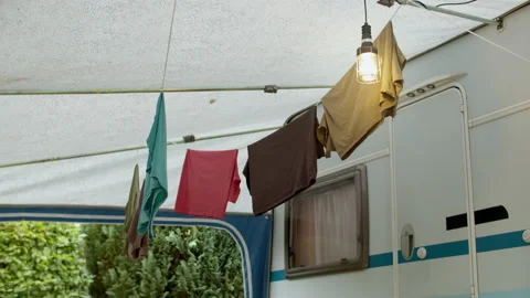 Different colored t-shirts on a clothes line lightly waving in the wind Stock Footage 211501966