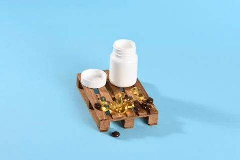 Different colored tablets and omega 3 Stock Photos