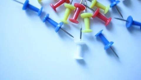 Different colors of buttons in motion on a white table surface Video stock 90363754