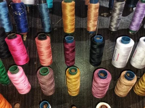 Different colors of thread are arranged. Stock Photos