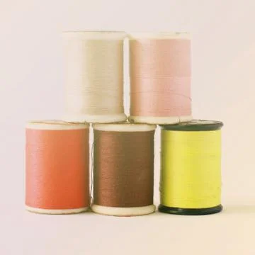 Different colors of thread spools with retro filter effect Foto stock