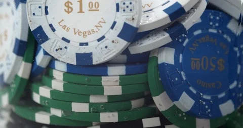 Different colour poker chips removed from into water Stock Footage 112330444