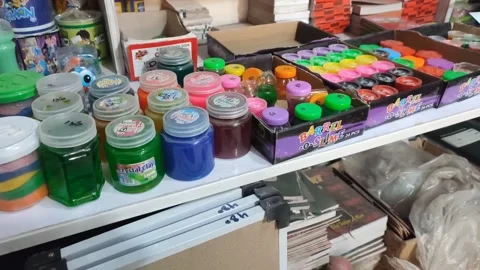 Different colour Slime in different bottles in a shop 動画素材 232331568