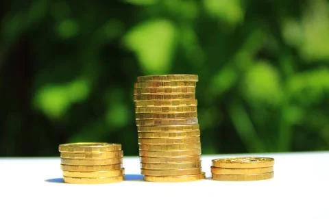 Different columns with coins Stock Photos