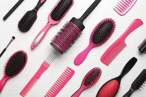 Different combs and brushes on white wooden background, closeup Stock Photos