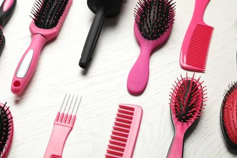 Different combs and brushes on white wooden background, closeup Stock Photos