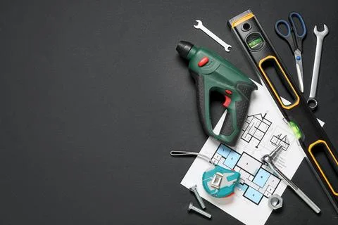 Different construction tools and house plan on black background Stock Photos