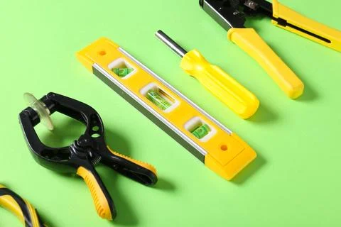 Different construction tools on green background, closeup Stock Photos