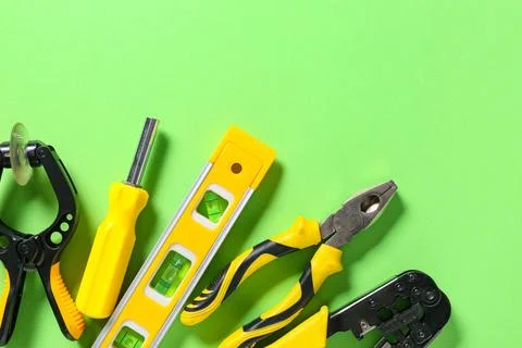 Different construction tools on green background Stock Photos