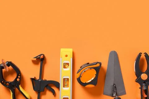 Different construction tools on orange background Stock Photos