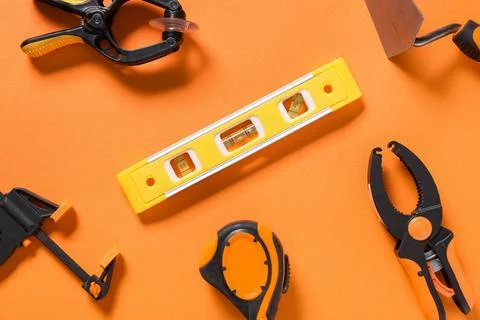 Different construction tools on orange background Stock Photos