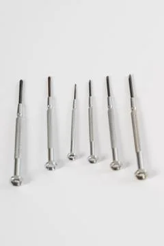 Different construction tools on a wooden background - screwdriver, caliper Stock Photos