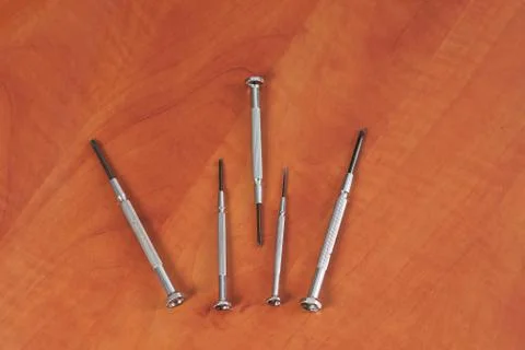 Different construction tools on a wooden background - screwdriver, caliper Stock Photos