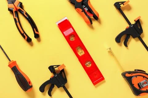 Different construction tools on yellow background Stock Photos