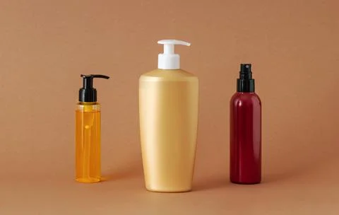 Different containers for cosmetics on a beige background. Stock Photos