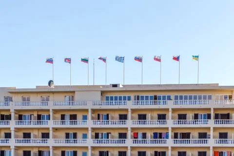 Different countries flags on hotel building Fotos de archivo