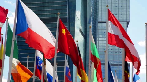 Different countries flags waving near skyscraper Video stock 56347625