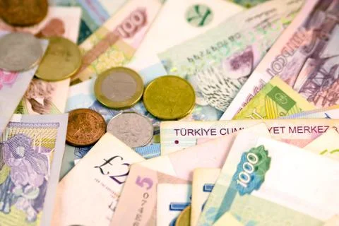 Different currency note and coins from different countries background Foto stock