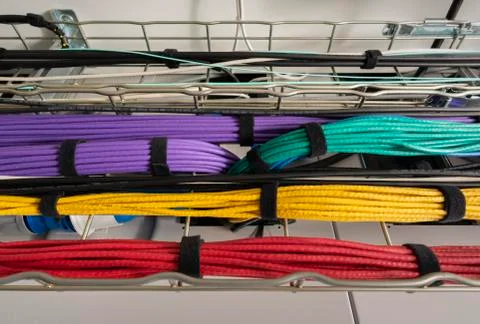 Different data cables running underneath ceiling in modern datacenter Stock Photos