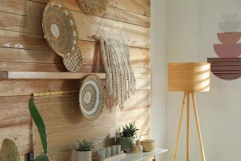 Different decorative elements on wooden wall indoors. Interior design Stock Photos