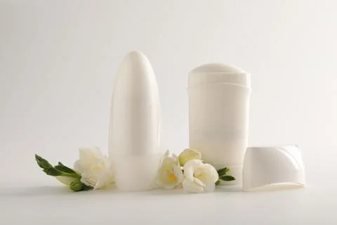 Different deodorants and beautiful eustoma flowers on white background 스톡 사진