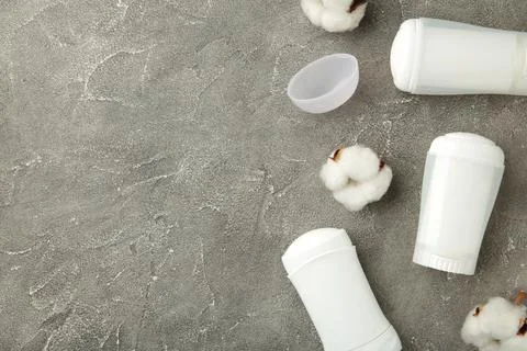 Different deodorants with cotton on grey background with copy space. Stock Photos