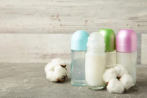 Different deodorants with cotton on light background with copy space. Stock Photos