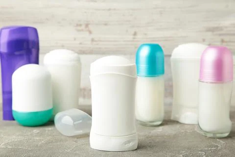 Different deodorants on grey background, top view. Skin care Stock Photos