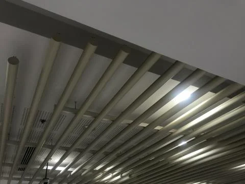 Different designs of Gypsum false ceiling with Epoxy coated MS pipes fixed fo 库存照片
