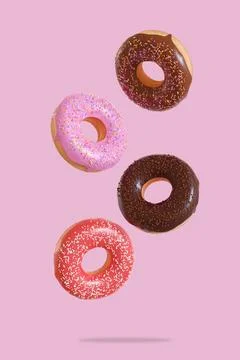 Different donuts fly on a pink background. Minimal concept. 3d render Stock Illustration