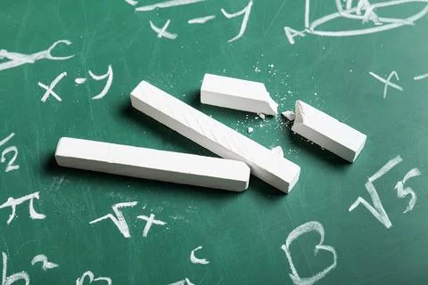 Different drawn geometric figures and math formulas with white chalks on gree Stock Photos