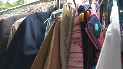 Different dresses and suits displayed on a market. Stock Footage 111141719