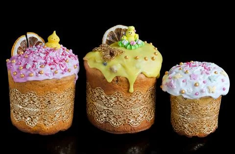 Different Easter cakes decorated with icing on a black horizontal background. 写真素材