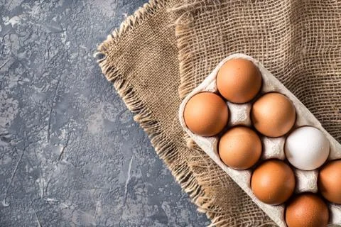 Different eggs in carton pack  on dark stone table Stock Photos