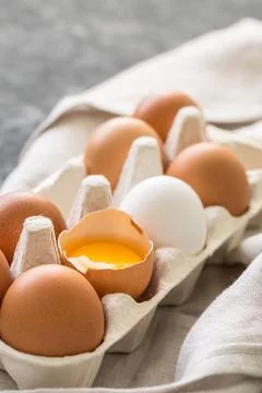 Different eggs in carton pack  on dark stone table. Stock Photos