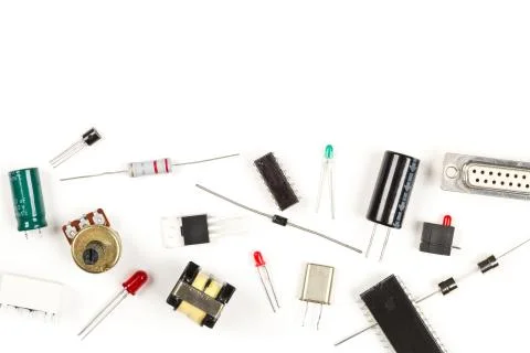 Different electronic parts or components on white with resistors, capacitors, Stock Photos